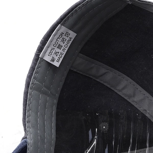 Macro shot of 100% cotton washed baseball cap interior with stitching and care label details