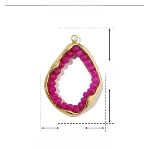 Detailed view of irregular gold stainless steel frame with rose red glass stone pendant
