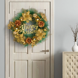 Golden Christmas wreath with Merry Christmas sign on light wood door for festive decoration