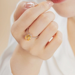 Macro shot of a luxury S925 silver ring featuring a large yellow zircon and pavé diamonds