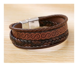 Close-up of multi-layer leather bracelet with embossed patterns and silver magnetic clasp