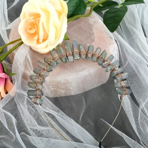 Handmade iridescent raw crystal crown headband on soft fabric with decorative roses