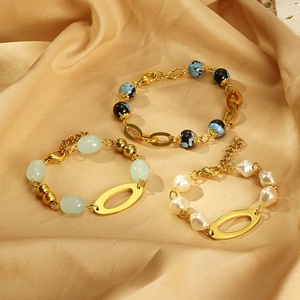 Detailed view of assorted resin bead bracelets with gold stainless steel links on silk