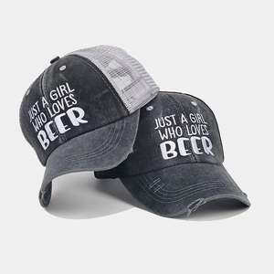 Close-up of distressed baseball caps with mesh back and JUST A GIRL WHO LOVES BEER embroidery