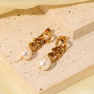 Close-up of 18K gold plated Cuban chain earrings with baroque freshwater pearls