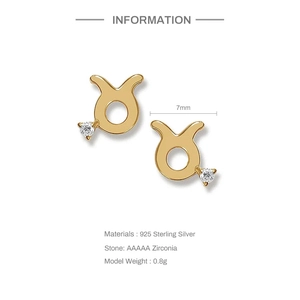 Macro detail of golden Taurus stud earrings in S925 silver with AAAAA zircon stones