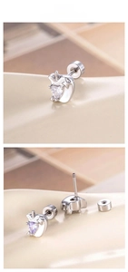 Detail view of apple-shaped cartilage studs with heart-shaped purple and clear zircons