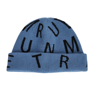 Detail of navy blue beanie featuring knitted black alphabet patterns and cuffed rim