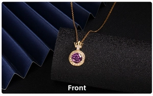 Detail of a purple gemstone pendant with a gold crown design and diamond accents