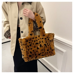 Close-up of plush leopard print tote bag showing soft faux fur texture and handle