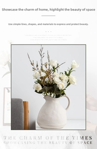 Macro shot of a matte white ceramic vase with stone texture and elegant white roses