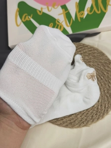 Close-up of white breathable mesh socks with exquisite bow embroidery and cute details
