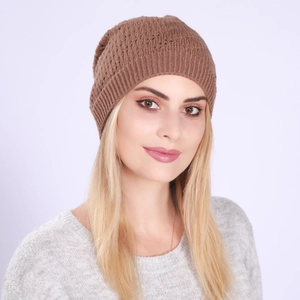 Detail of a brown knit beanie featuring intricate hollow patterns and ribbed edge for women