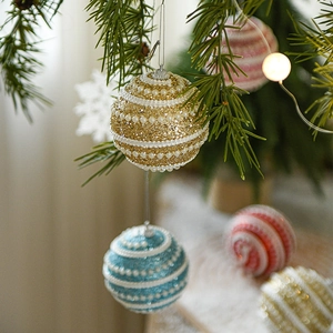 Glittery Christmas ball ornaments with pearls and thread detailing for tree decoration