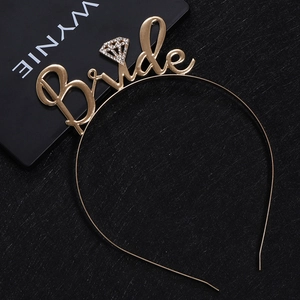 Close-up of golden Bride metal headband with sparkly rhinestone diamond detail