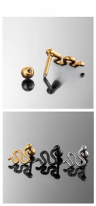 Macro detail of snake-shaped stud earrings in gold, silver, and black finishes