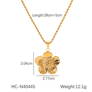 Detail view of gold flower pendant necklace with dimensions 3.04cm height and 39cm chain length