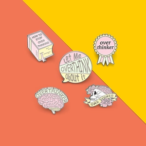 5-piece pink and cream enamel pin set with Overthinker skull book and brain designs