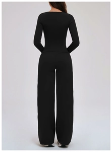 Close-up of the back view of a black slim-fit yoga set with long sleeves and wide-leg pants