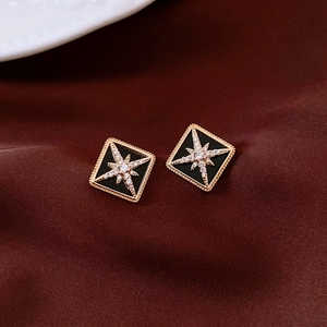 Macro view of vintage 16K gold plated diamond-shaped studs with a star pattern