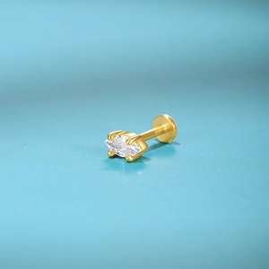 Macro view of a gold marquise-cut crystal earring with flat back piercing detail