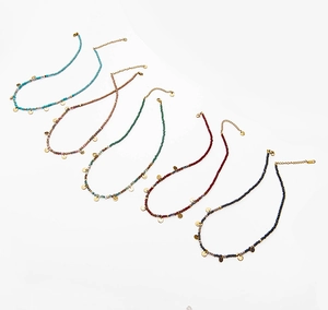 Detail view of colorful natural stone beaded necklaces with gold stainless steel discs