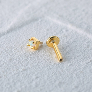 Macro shot of 925 silver gold-plated opal labret stud with a square claw setting