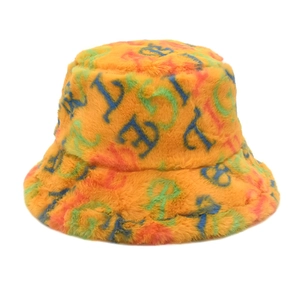 Detail of bright orange fuzzy bucket hat featuring colorful letter print and plush faux fur