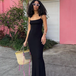 Slim fit black backless maxi dress with thin straps and minimalist style for vacation