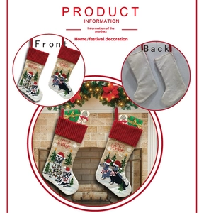 Detail of burlap Christmas stockings with dog embroidery and red ribbed cuffs set