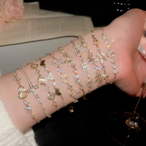 Elegant gold plated bracelet set with cat eye stones and sparkling butterfly charms