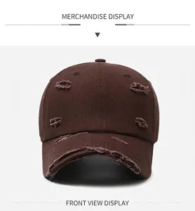 Front view of a distressed dark brown baseball cap with frayed edges and ripped details
