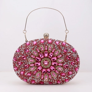 Macro shot of pink rhinestone evening clutch with crystal floral patterns and golden chain