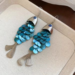Elegant fish-shaped shell tassel drop earrings with evil eye detail for beach vacation