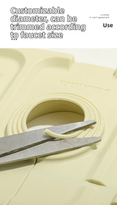 Close-up of cutting the adjustable center hole on a cream silicone faucet drain mat