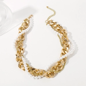 Vintage gold layered chain necklace with white pearls for women on white backdrop