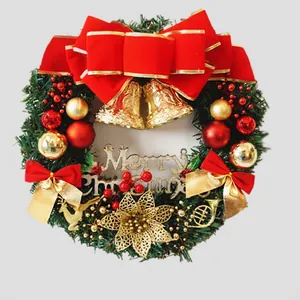 Christmas wreath with red velvet bow, gold bells, and Merry Christmas sign on pine needles