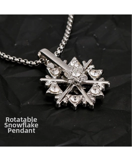 Macro shot of rotatable titanium steel snowflake pendant with inlaid crystals on black background