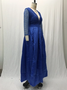 Détail de la dentelle brodée bleu marine et du tissu en satin brillant sur la robe