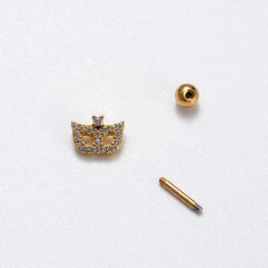 Detail view of gold-plated crown piercing stud with zirconia and screw ball backing