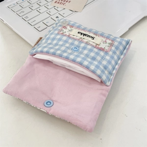 Detailed view of the blue checkered fabric pouch with snap button and pink lining
