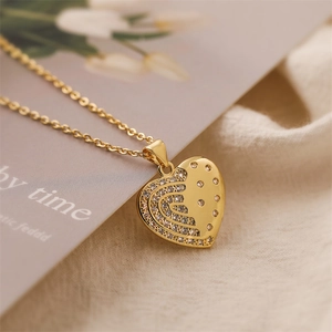 Close-up of heart pendant necklace in gold finish with micro-pave cubic zirconia details