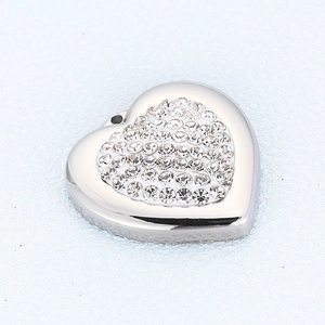 Macro shot of silver heart pendant with sparkling pavé-set clear zircon stones