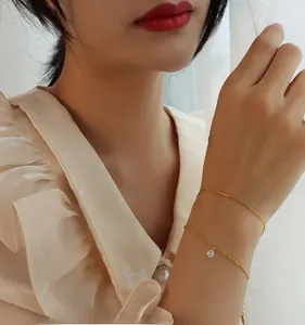 Detail view of double-layered 18k gold-plated titanium steel bracelet with zircon stone