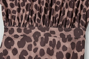 Detail of pleated leopard print fabric on an elegant long sleeve autumn dress