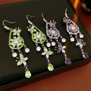 Detail of elegant zircon flower earrings with purple and green teardrop dangles