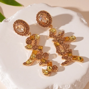 Detailed shot of golden Chinese New Year earrings with sparkling yellow rhinestones
