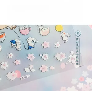 Detail of KX028 5D embossed nail stickers featuring rabbit and cherry blossom patterns