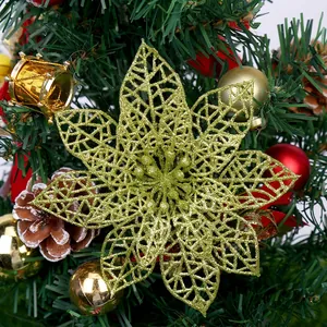 Golden glitter hollow poinsettia flower ornament hanging on a Christmas tree