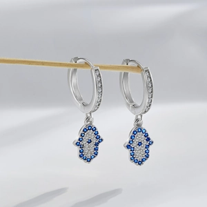 Detail of S925 sterling silver Hamsa Hand earrings with blue and white zircons